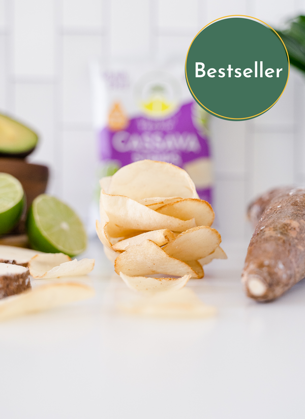 Bestseller A stack of Artisan Tropic's 9 oz Sea Salt Cassava Strips With Raw Cassava and limes in the background