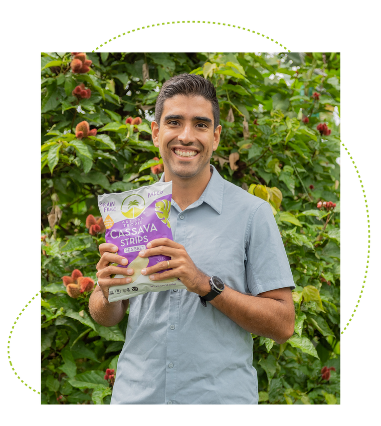 Young man smiling and holding a bag of Artisan Tropic's Sea Salt Cassava Strips